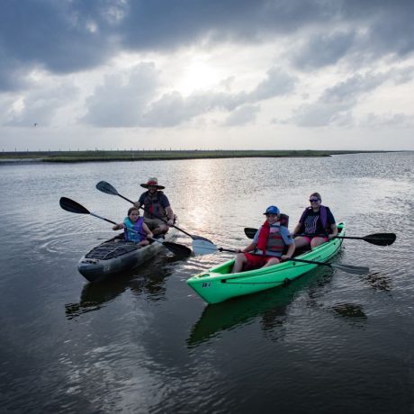 Family kayaking at the canal at Blue Water RV Resort