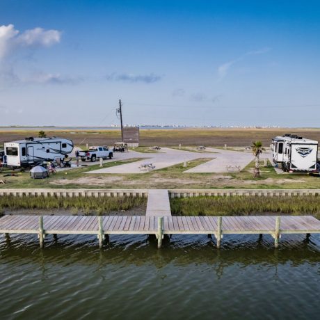 Aerial view of RV sites and the dock at Blue Water RV Resort along the canal